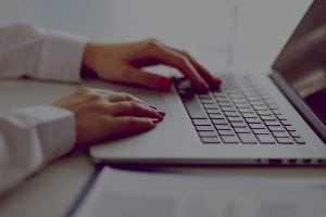 Closeup (hands and wrists) of woman using laptop
